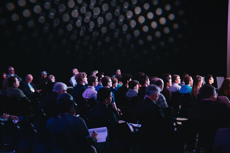 a crowd waits to hear a keynote speech