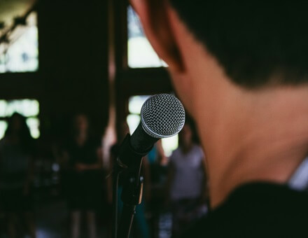 A public speaker steps up to the microphone
